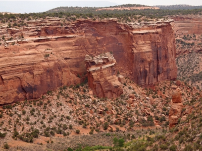 [Photo focuses on the chunk of canyon wall that now has its top half about halfway down the canyon wall as if it were a block of ice melting into the ground.]